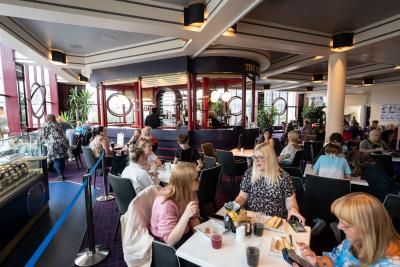 An image of a group of people sat at tables in the Dress Circle Cafe